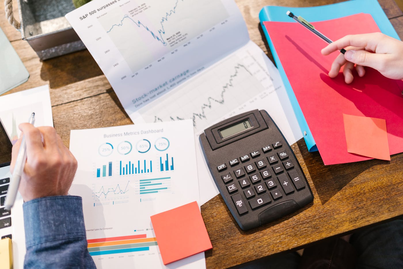 Financial documents, charts, and analysis tools arranged on a professional desk