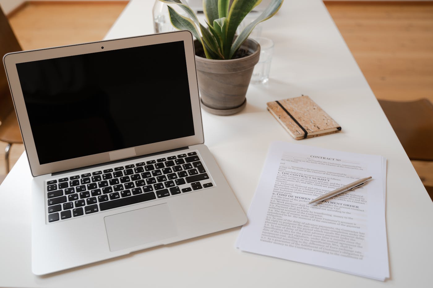 Clean, organized office desk with laptop and financial documents